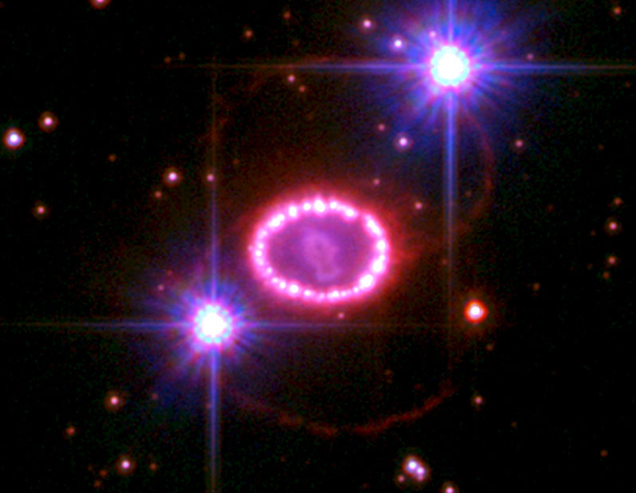 This Hubble Space Telescope image of the remnant of Supernova 1987A shows a bright inner ring glowing as it interacts with material from the supernova blast. The ring is approximately one light-year in diameter. It is not clear what is causing the two larger, fainter rings. The two bright objects are stars in the Large Magellanic Cloud. The image was taken in 2010. Image: NASA, ESA, R. Kirshner and P. Challis (Harvard-Smithsonian Center for Astrophysics)