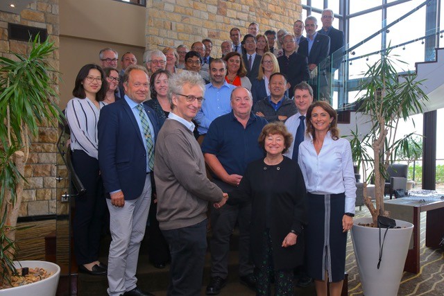 Chair of the SKA Board of Directors Dr Catherine Cesarsky shakes hands with French representative Michel Pérault, marking the occasion with members of the Board and observers.