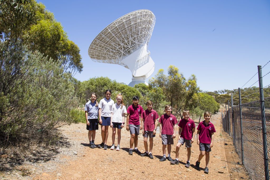 Current and ex Dalkeith Primary School students with the European Space Agency 35m tracking dish in New Norcia. The dish has just started tracking Proxima Centauri in preparation to send the students' message to our nearest stellar neighbour.