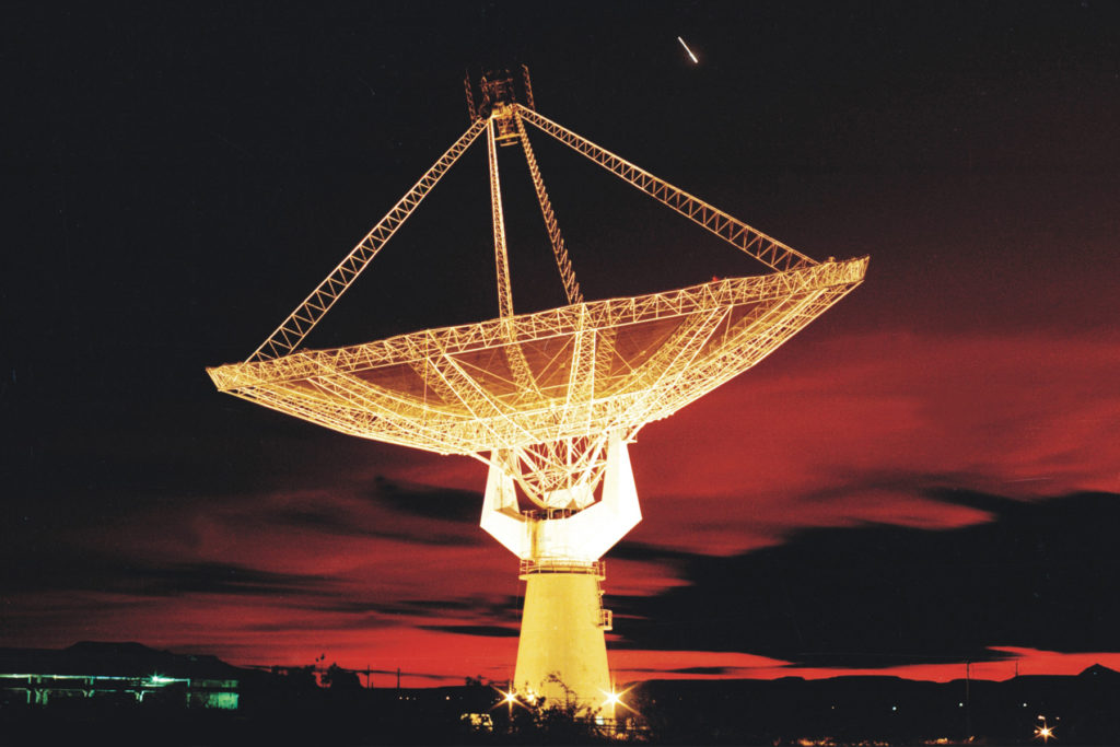 A view of a GMRT antenna lit up at night